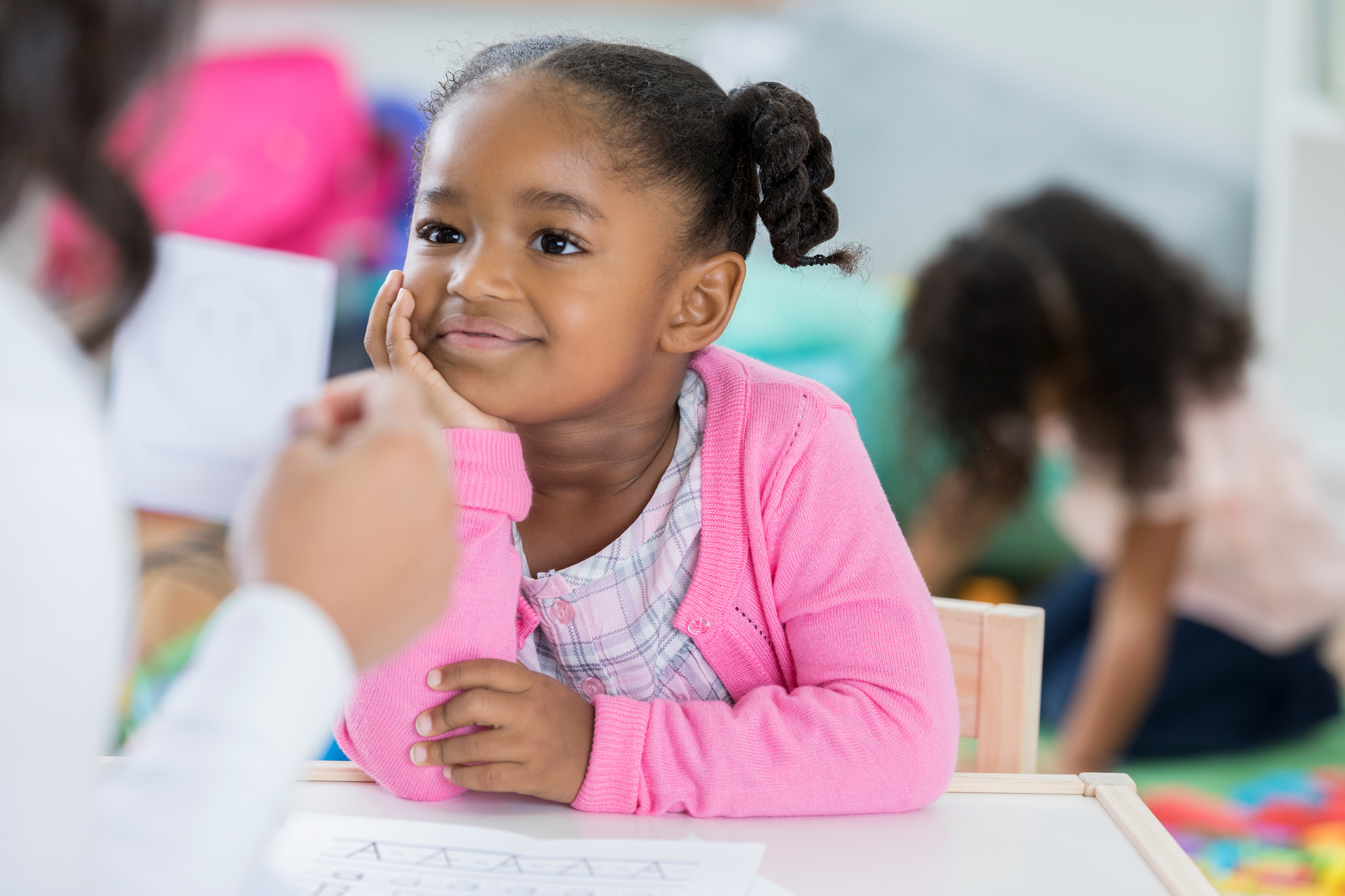 Confident African American preschool student reviewing flashcards