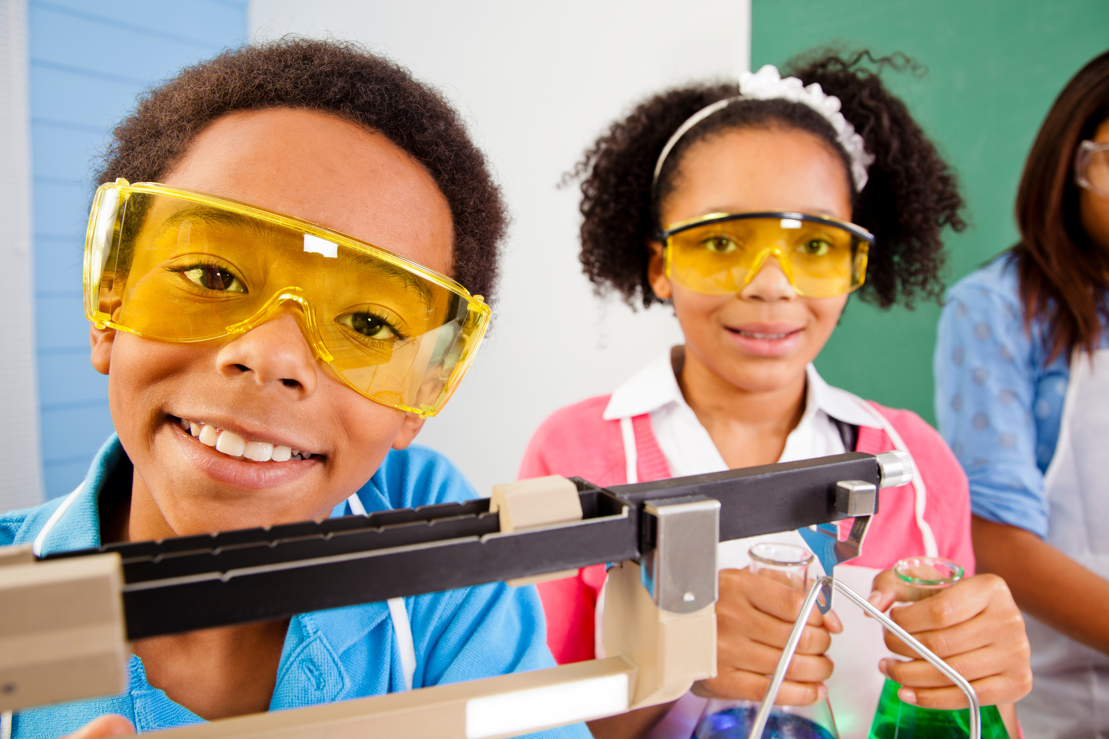 African American students science lab safety glasses scale and beakers