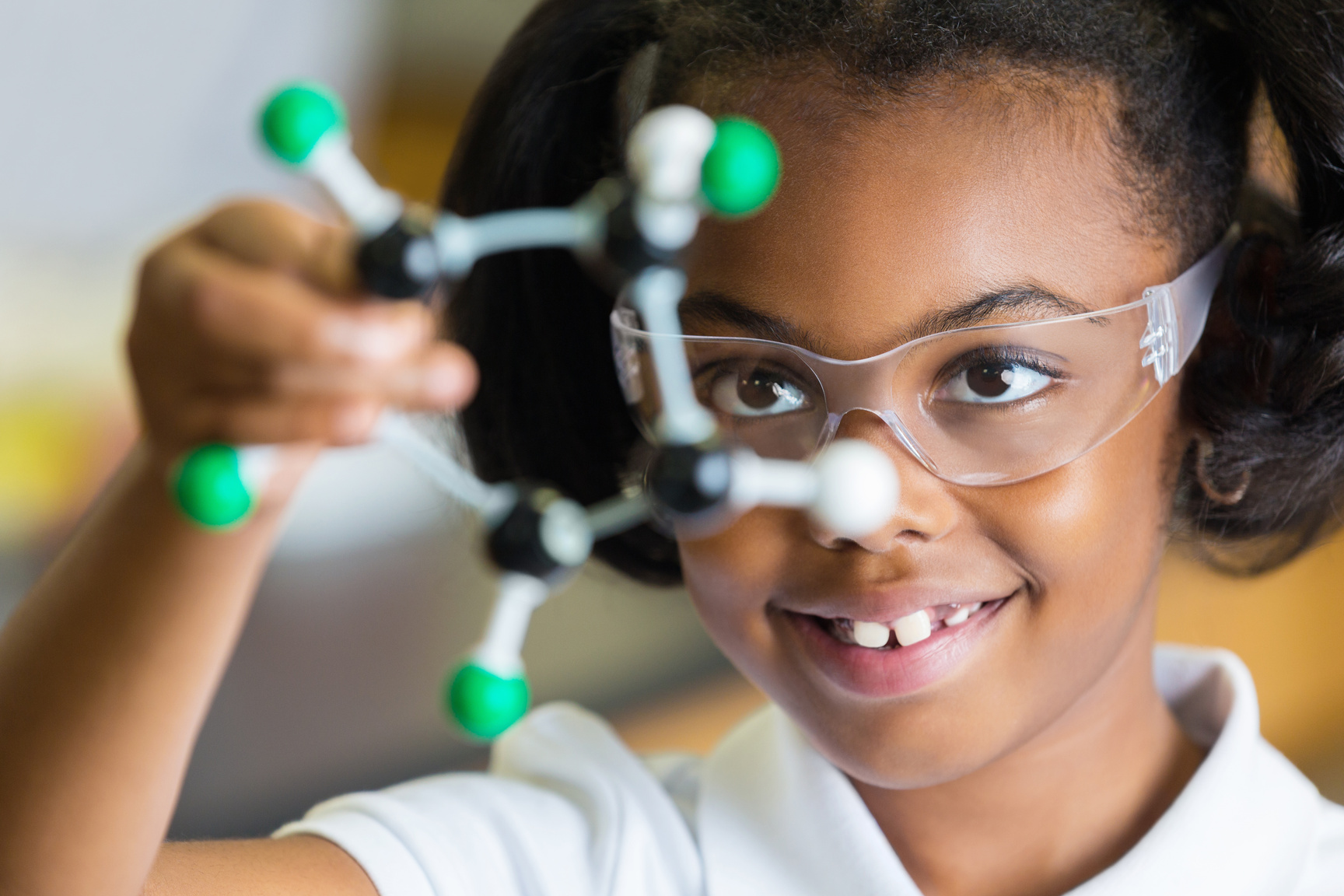 African American private elementary student studying model in science class